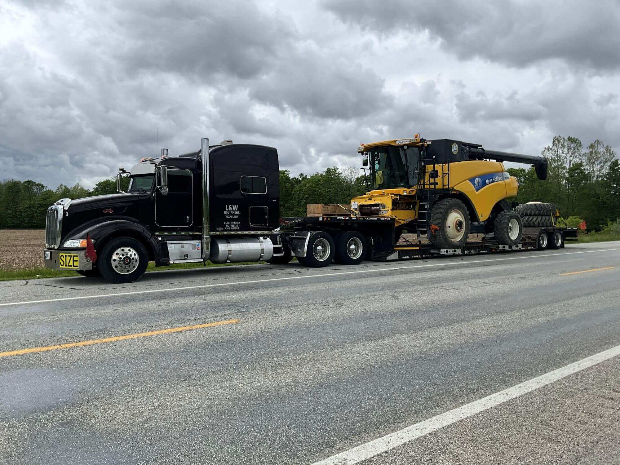 Truck hauling ag equipment